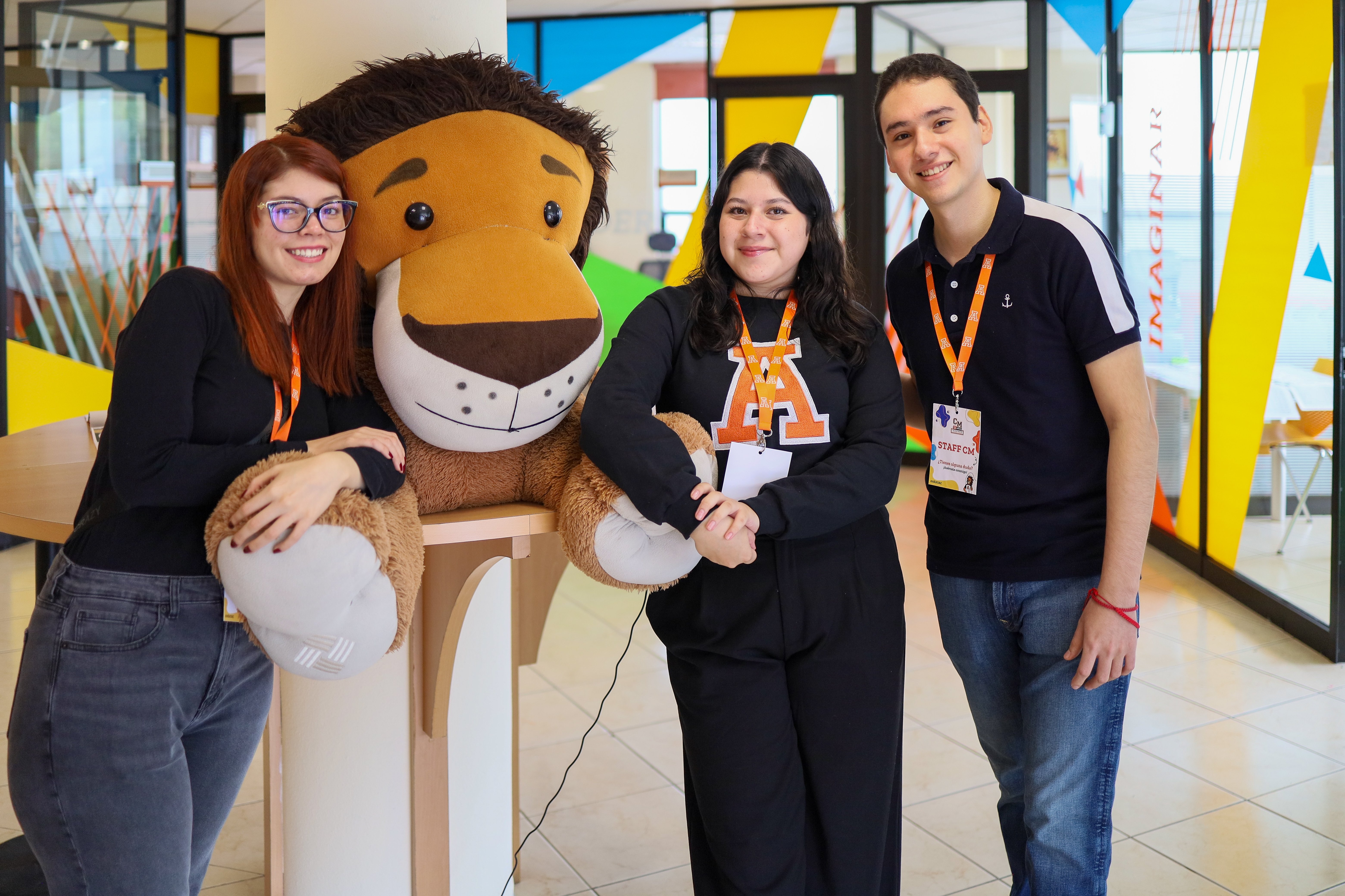 3 alumnos posando junto a la mascota de la UAP 